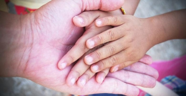 hands-of-adult-and-child-together